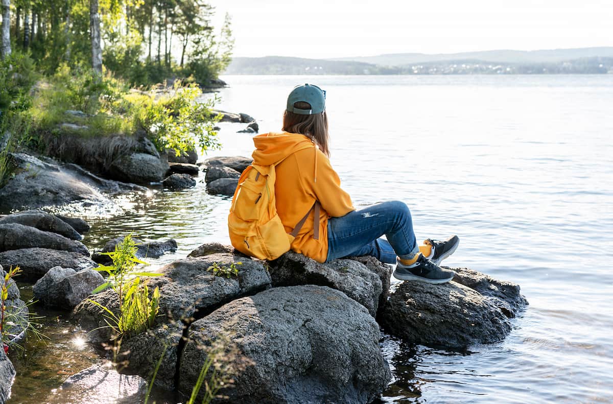 young-woman-wearing-cap-yellow-hoodie-with-backpa-2022-09-26-22-54-10-utc (1)